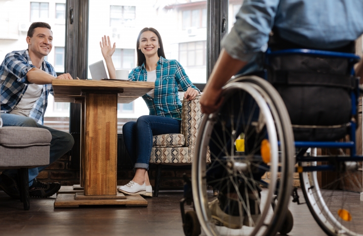 waving at a person on wheelchair